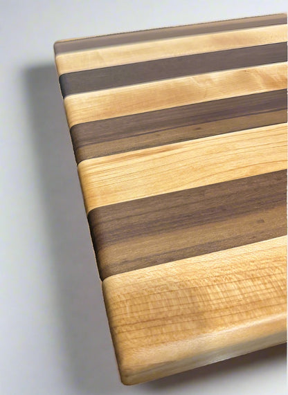 close up photo of the side of the two-toned walnut and hard maple cutting board